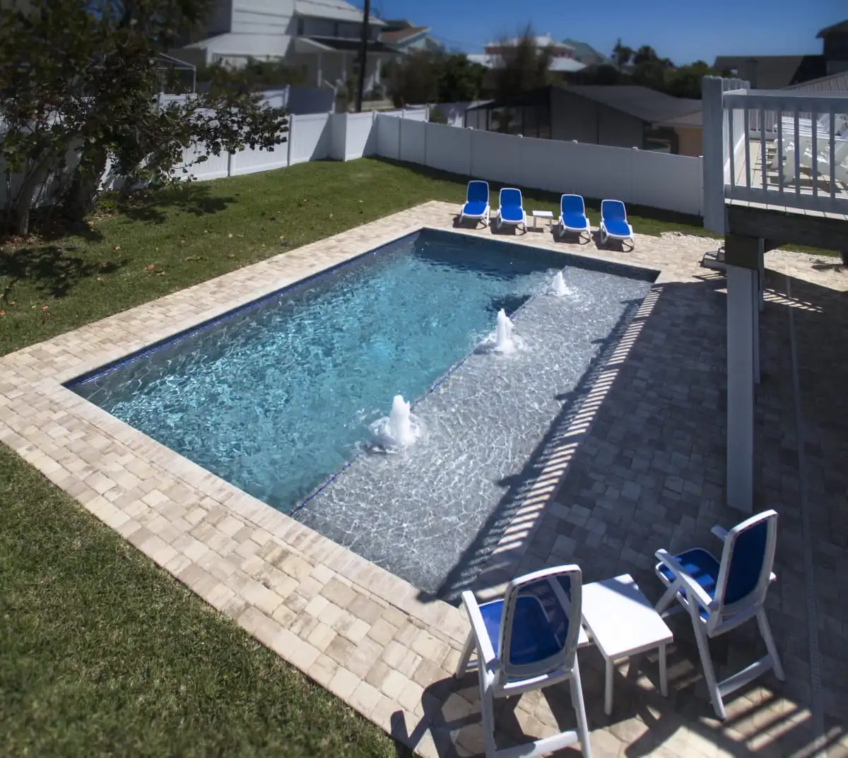 16-New-Smyrna-Beach-custom-pool-with-sun-shelf-and-paver-deck.jpg