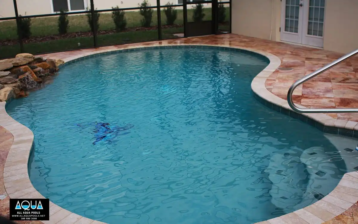 41-Free-form-pool-with-pink-travertine-decking-and-real-rock-waterfall.jpg
