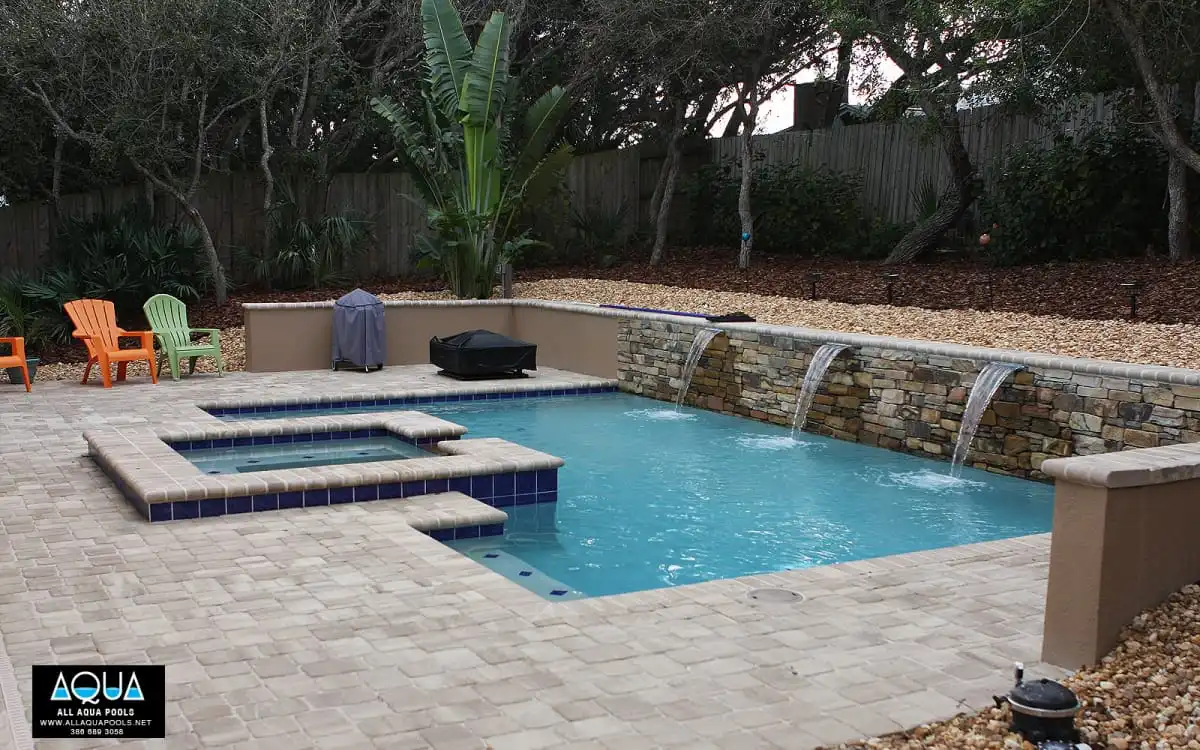 Modern-pool-with-rock-wall-and-three-waterfalls.jpg