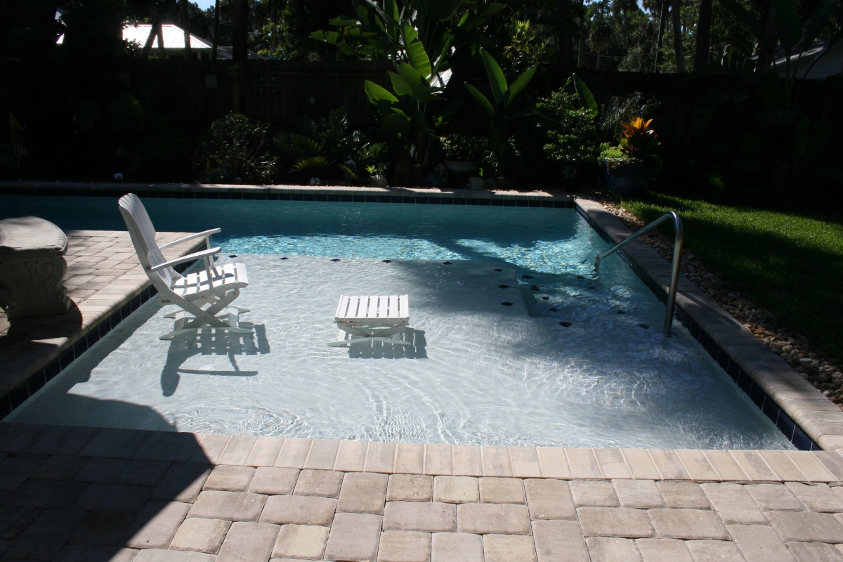 inground pool with sun shelf